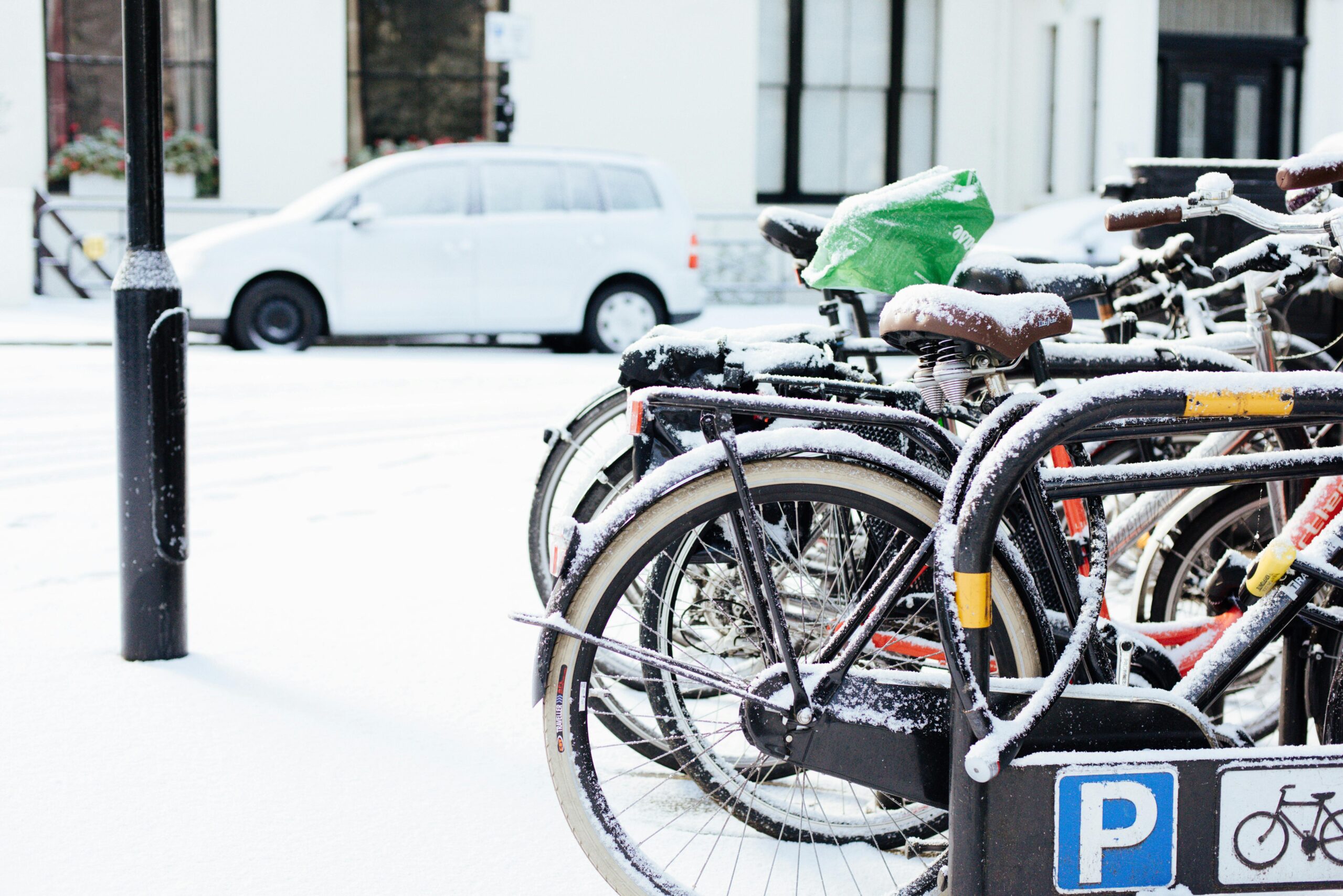 snow on parked bikes in London